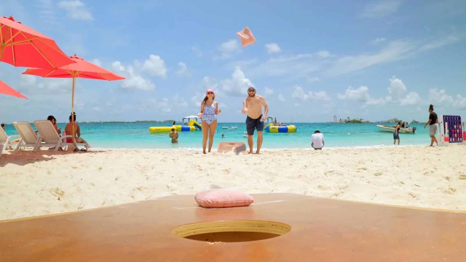 Sun loungers, a red umbrella and watersport kit set out on the Athol Island sand