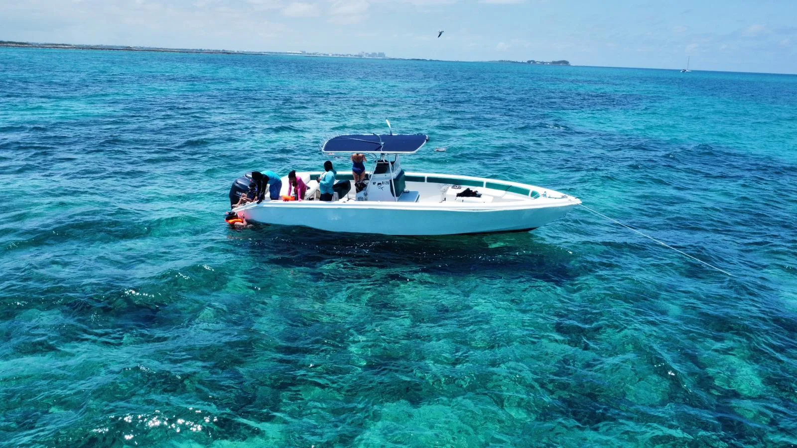 The charter's centre-console boat sitting alone on flat open water