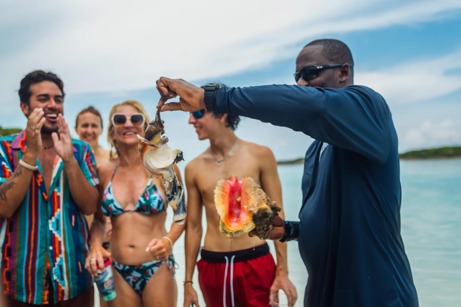 Guests photographing a crew member holding food up during the wildlife feed